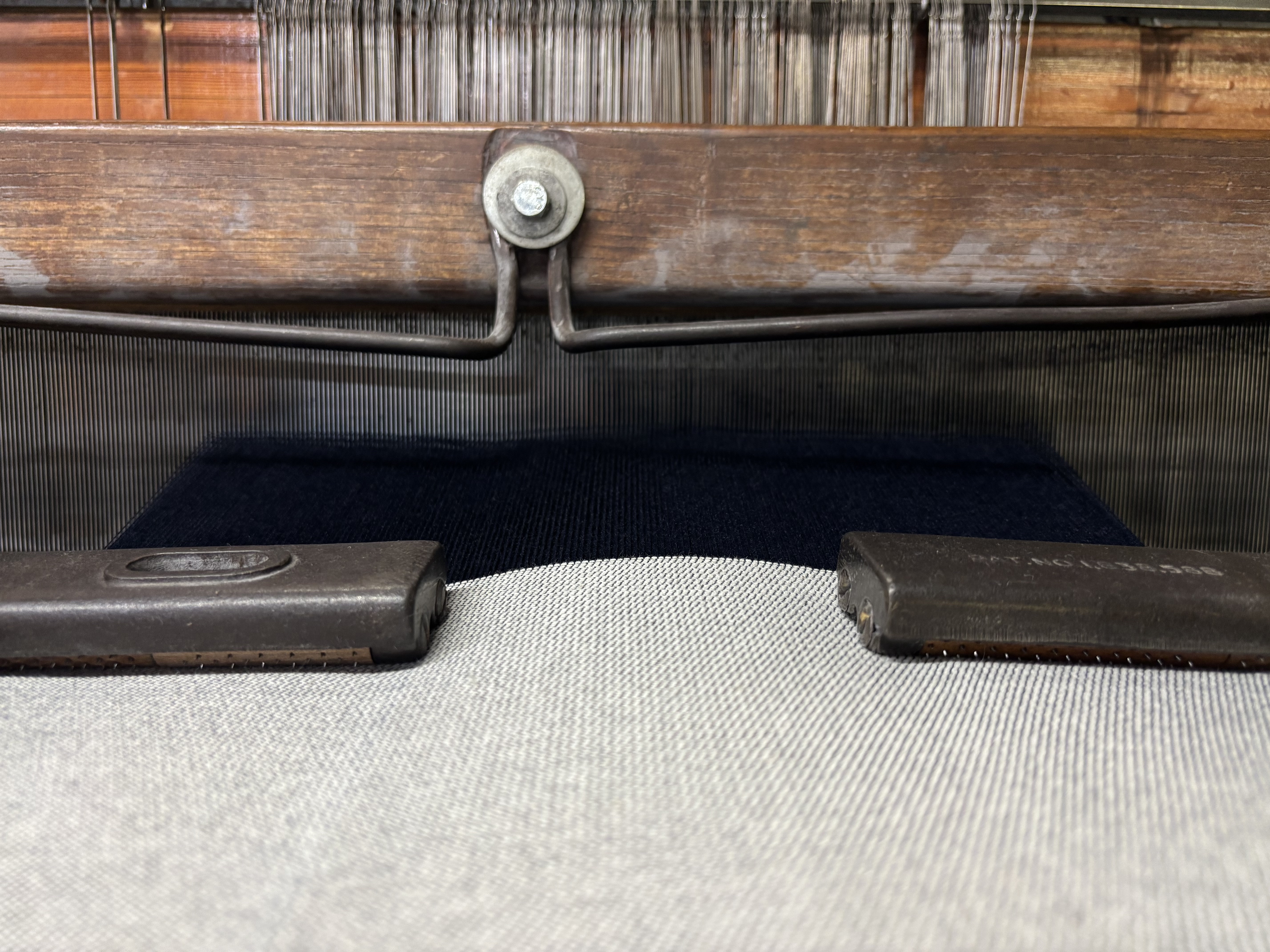 A modern US textile mill floor with rows of industrial looms